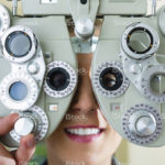 stock-photo-22987223-young-woman-at-phoropter-for-eye-test